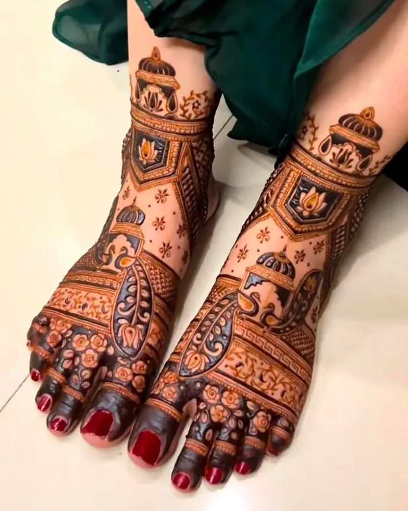 Bridal feet mehandi with dome and lotus design and red nail polish
