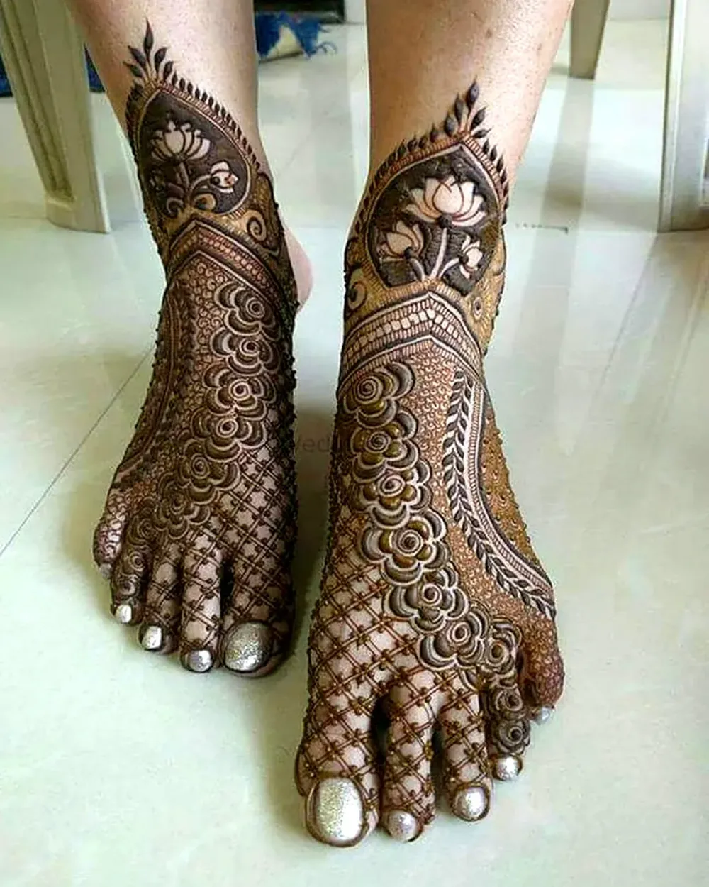 Fine jaal net pattern with lotus flowers on bridal feet