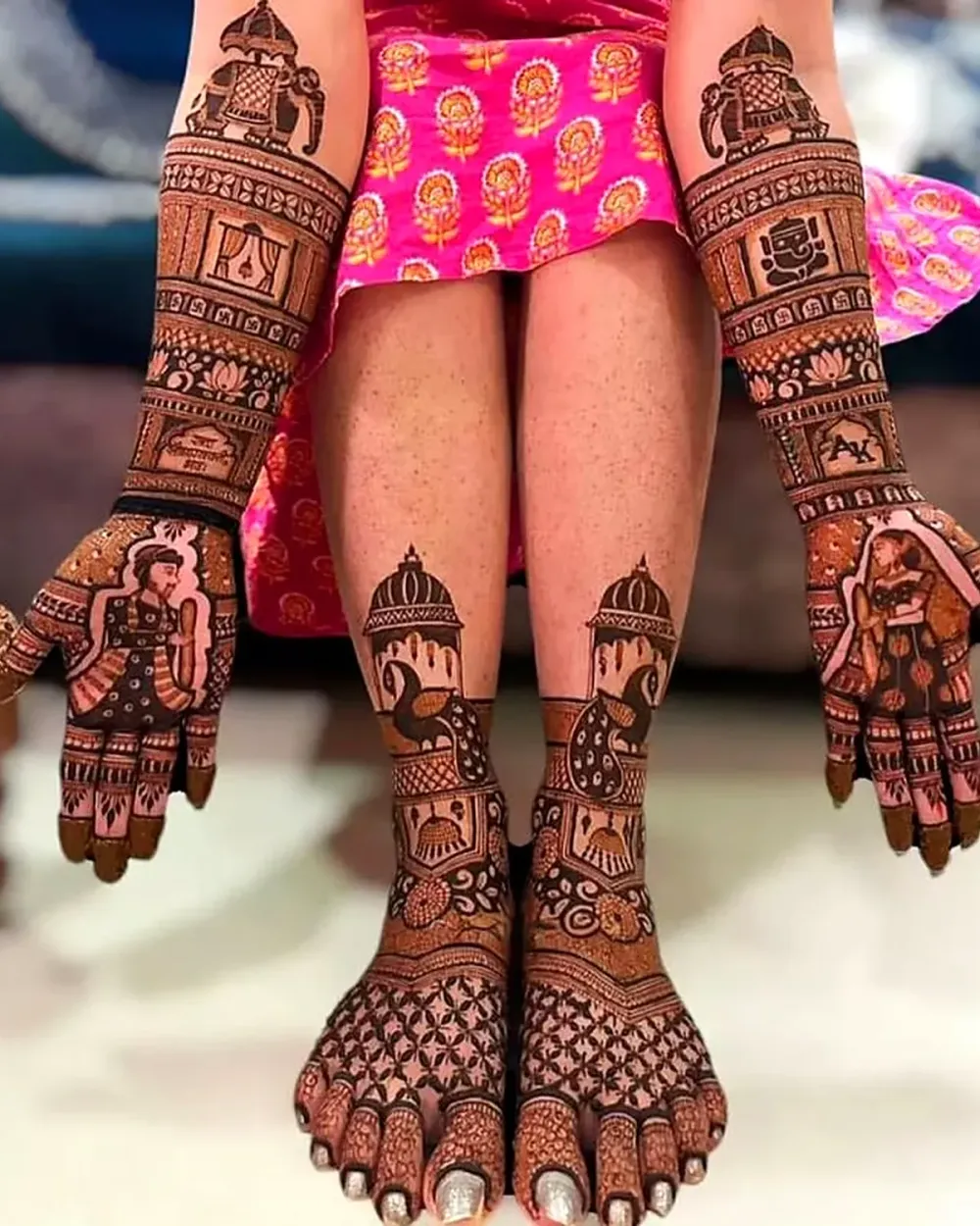 Complete bridal mehndi on both hands and feet with couple figures on the palms