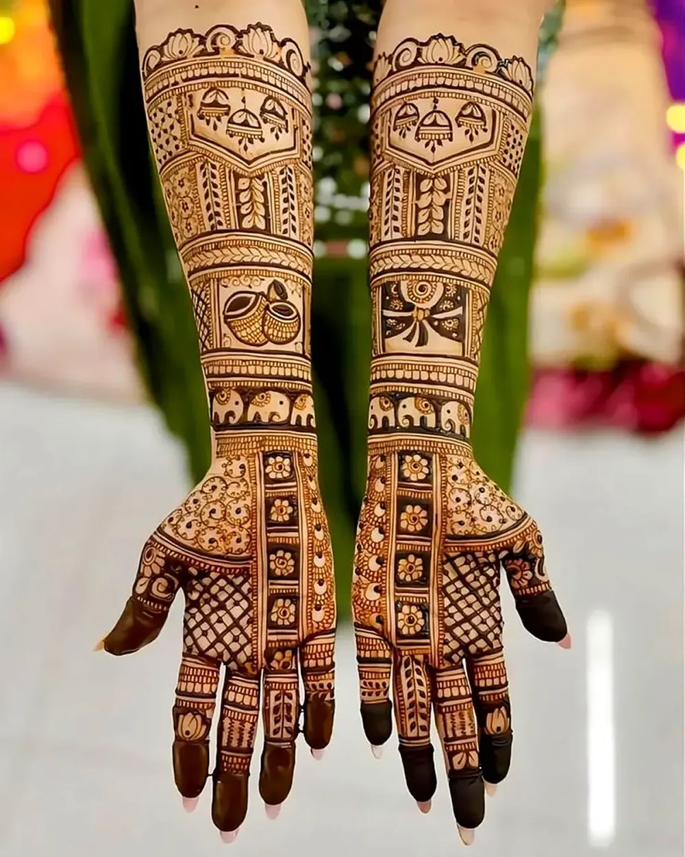 Dark bridal mehandi with kalash and jhumka panels on both arms