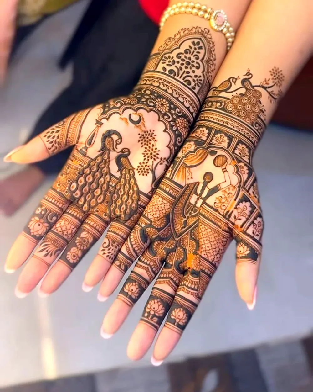 Mehendi on both hands with peacock, a dancing figure and fine finger work