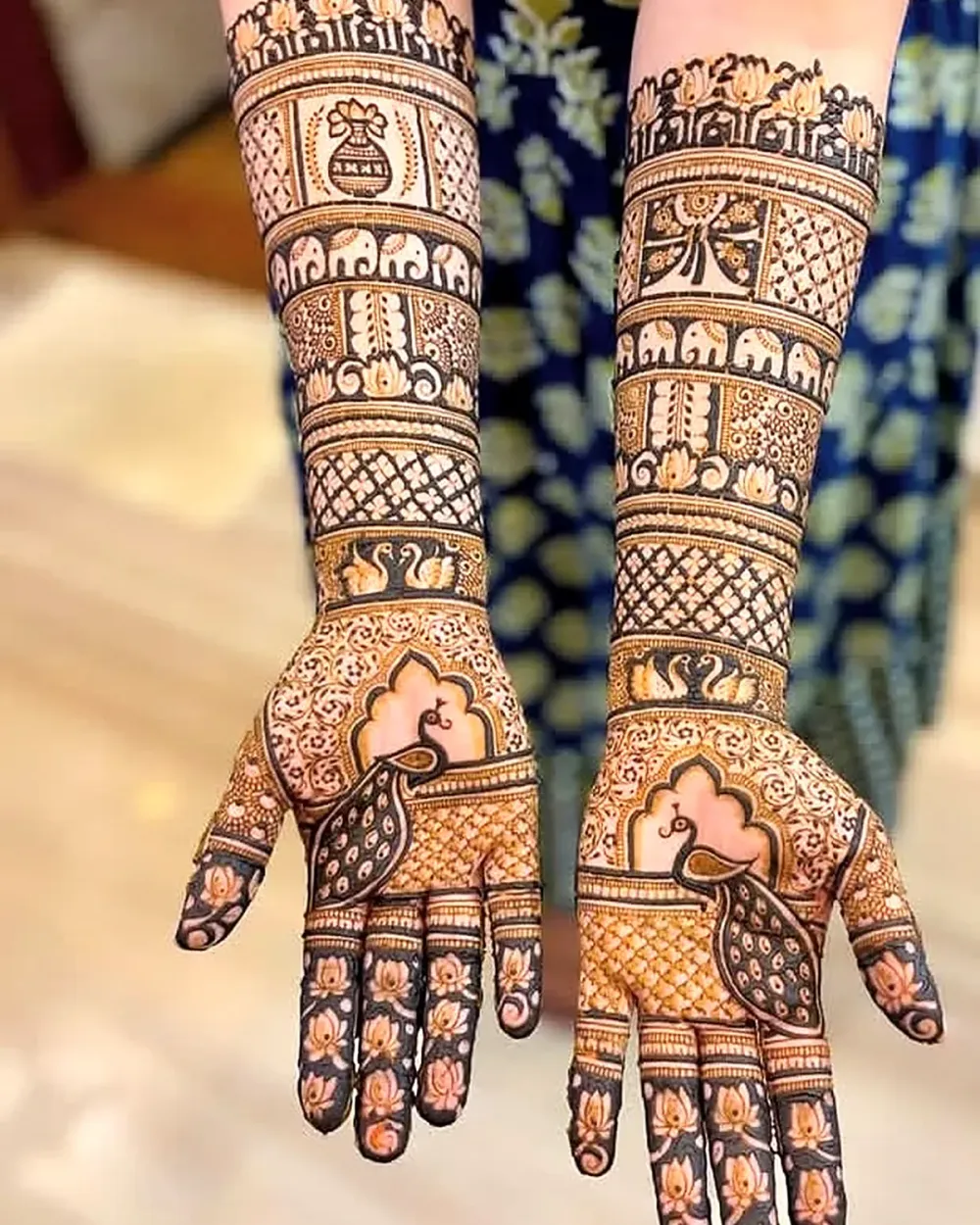 Bridal mehandi in Chandigarh with elephant, kalash and peacock design on both palms by Vijay Mehandi Artist