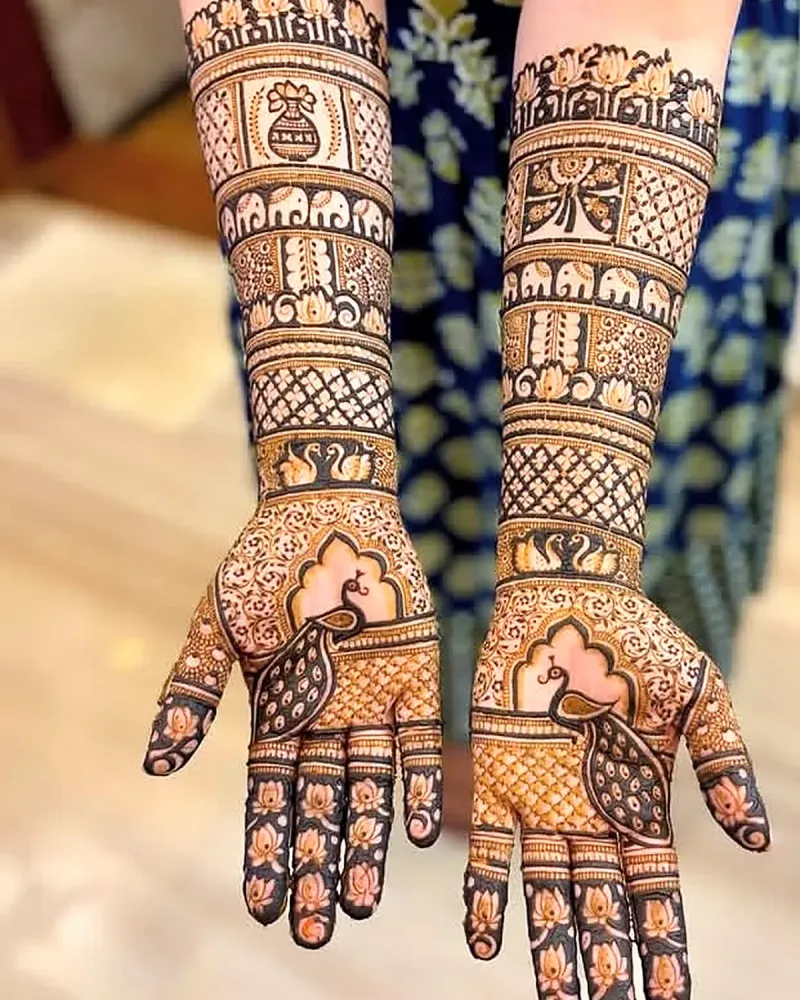 Bridal mehndi with elephant row, kalash and peacock on the palms
