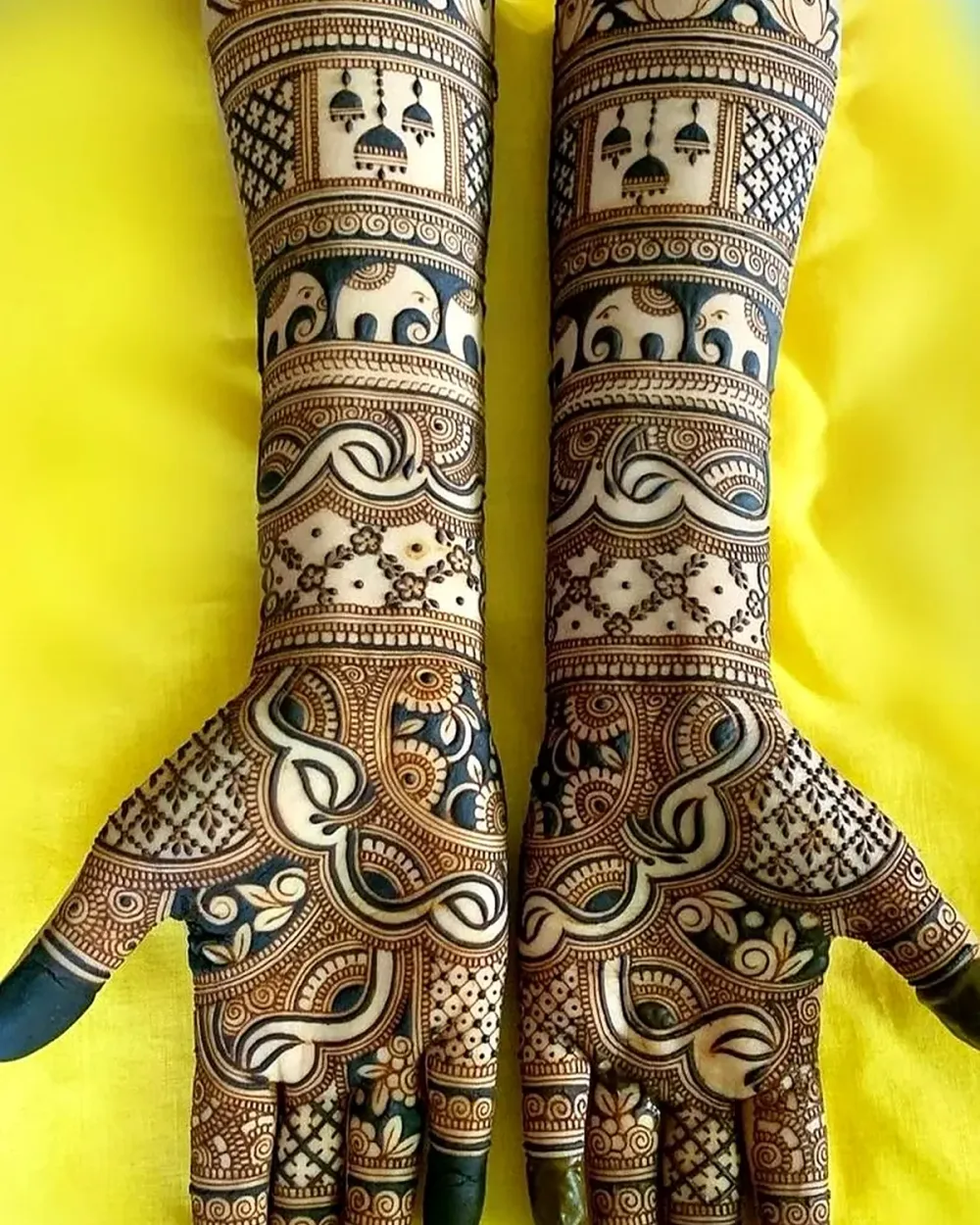 Full hand bridal mehndi with elephant, lotus and jhumka motifs by a Chandigarh mehndi artist
