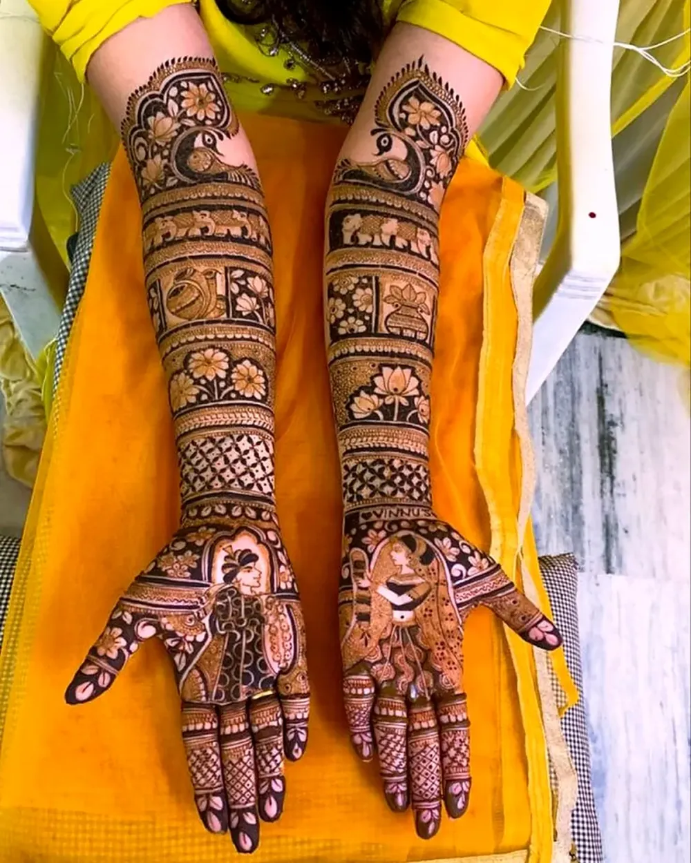 Dulha dulhan figures on the palms with peacock and elephant arms, bridal mehndi Chandigarh
