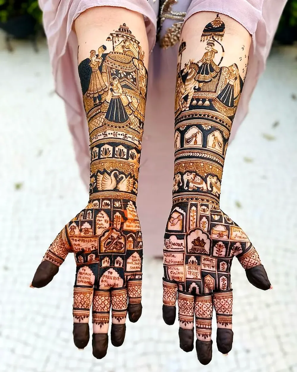 Wedding mehendi telling a baraat story with elephant and dulha dulhan on the palms